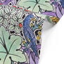 Detail of tea towel with a pattern of foliage, birds and strawberries.